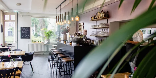 interior-shot-of-a-cafe-with-chairs-near-the-bar-with-wooden-tables