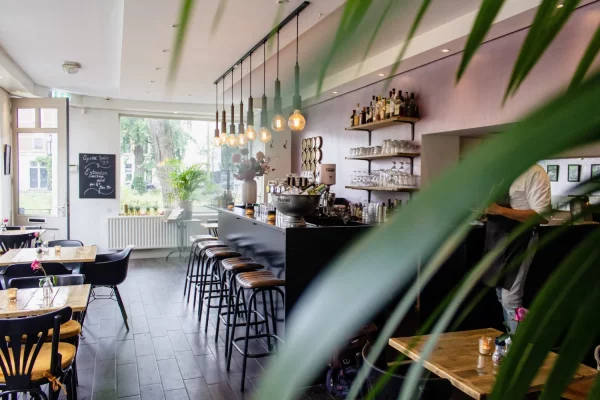 interior-shot-of-a-cafe-with-chairs-near-the-bar-with-wooden-tables